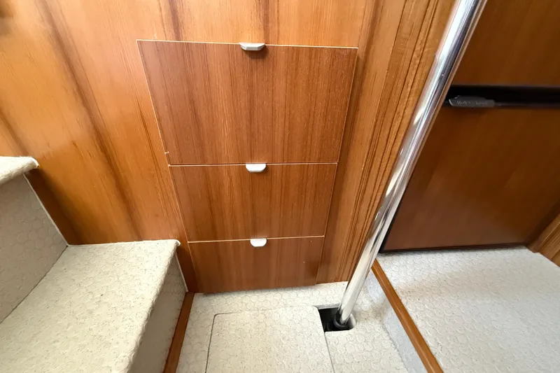 Slide: The Image of Interior of 2021 Ranger Tugs R-41CB with wooden cabinetry and carpeted stairs. - 29