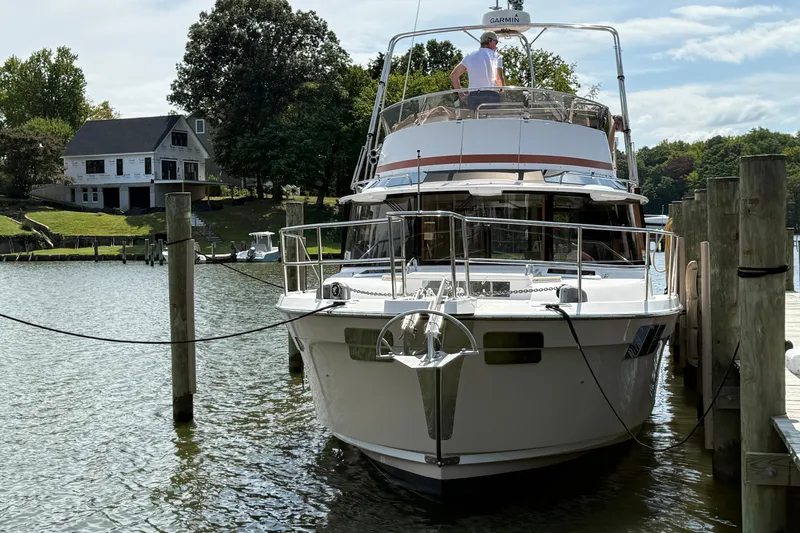 Slide: The Image of 2021 Ranger Tugs R-41CB yacht docked at a serene waterfront location. - 3