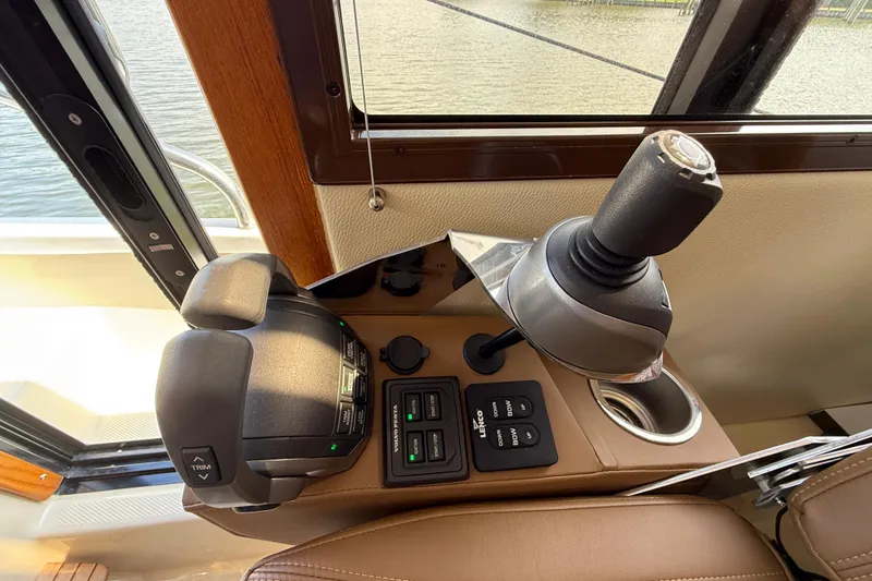 Slide: The Image of Control panel of 2021 Ranger Tugs R-41CB boat with joystick and throttle. - 32