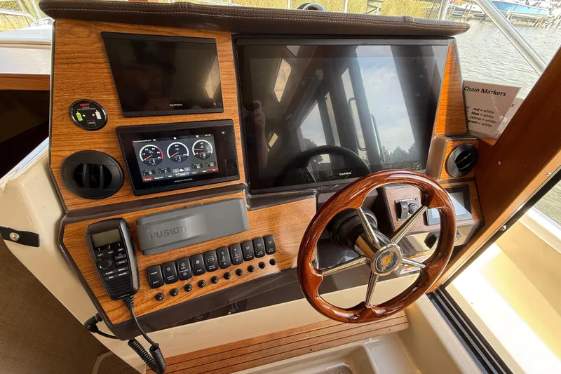 Slide: The Image of 2021 Ranger Tugs R-41CB helm with wooden steering wheel and modern navigation displays. - 33