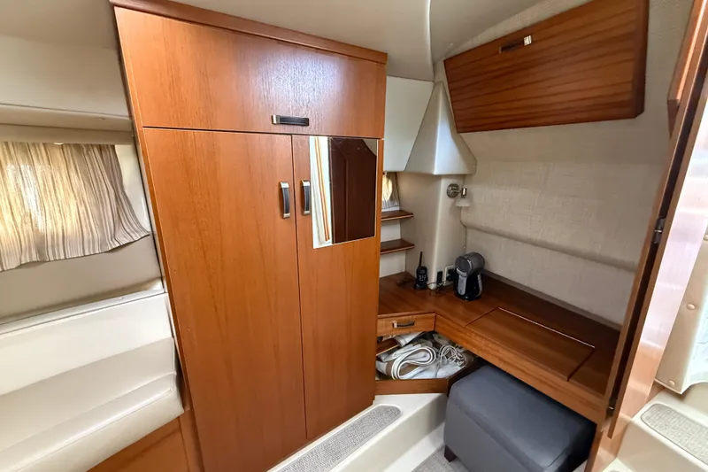 Slide: The Image of 2021 Ranger Tugs R-41CB cabin interior with wooden cabinetry and seating area. - 39