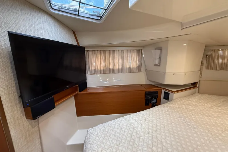 Slide: The Image of 2021 Ranger Tugs R-41CB cabin interior with TV and bed. - 42
