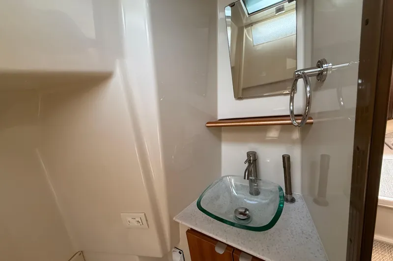 Slide: The Image of 2021 Ranger Tugs R-41CB bathroom with modern glass sink and mirror. - 43