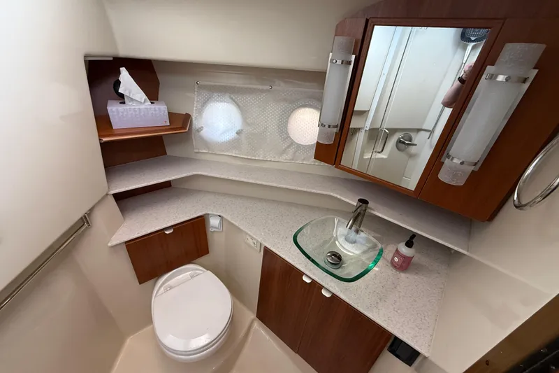 Slide: The Image of 2021 Ranger Tugs R-41CB bathroom with modern fixtures and wooden cabinetry. - 44