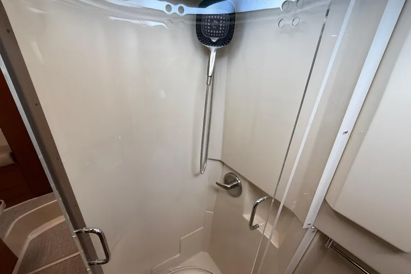 Slide: The Image of Shower area in 2021 Ranger Tugs R-41CB boat, featuring modern fixtures and glass door. - 45