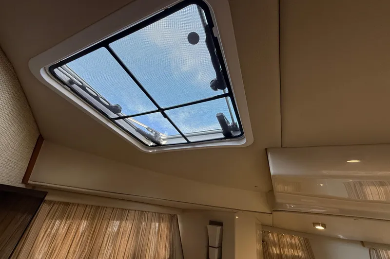 Slide: The Image of Interior view of 2021 Ranger Tugs R-41CB boat with skylight and curtains. - 46