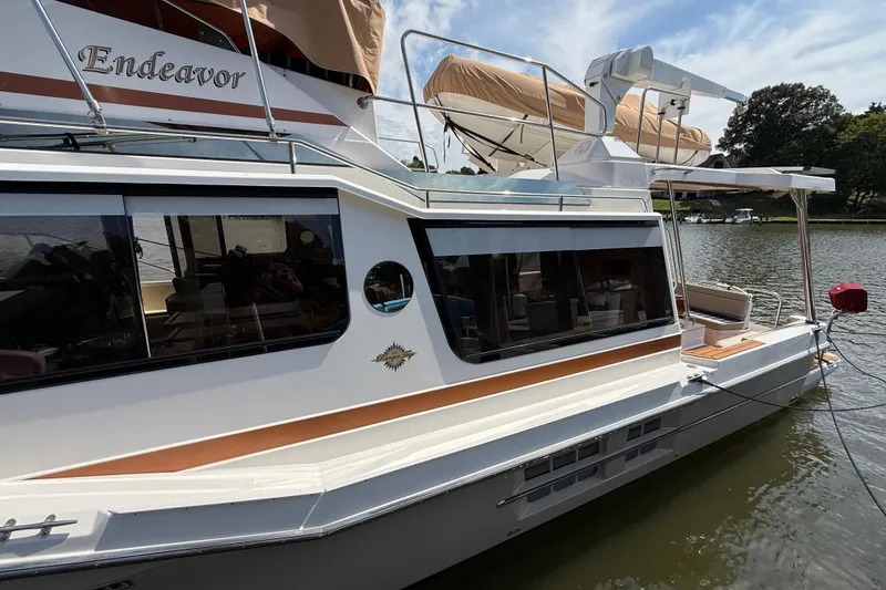 Slide: The Image of 2021 Ranger Tugs R-41CB boat docked on a calm lake. - 5
