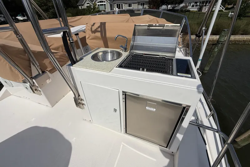 Slide: The Image of Outdoor kitchen on 2021 Ranger Tugs R-41CB boat with sink, grill, and fridge. - 50
