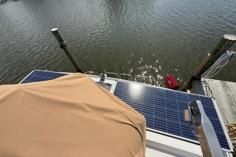 Slide: The Image of 2021 Ranger Tugs R-41CB with solar panels docked by the water. - 52