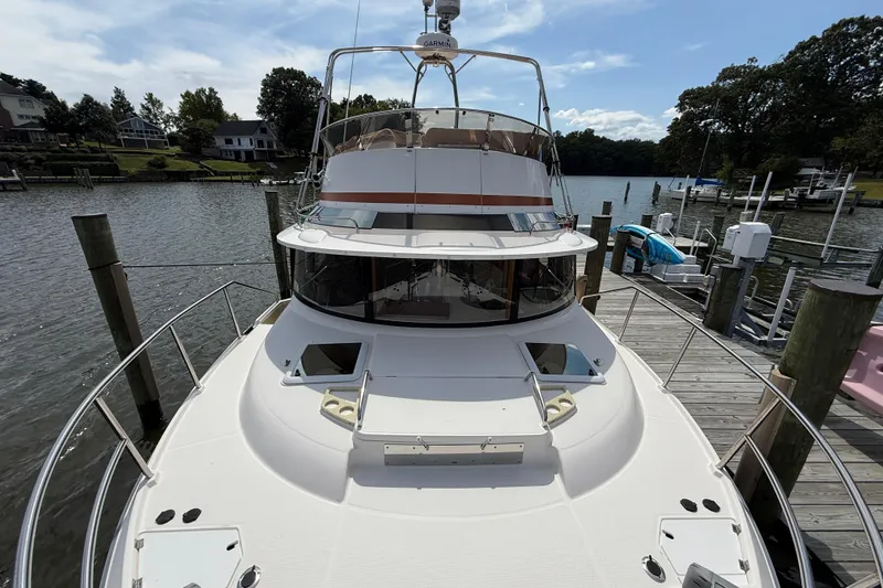 Slide: The Image of 2021 Ranger Tugs R-41CB yacht docked at a serene waterfront location. - 6