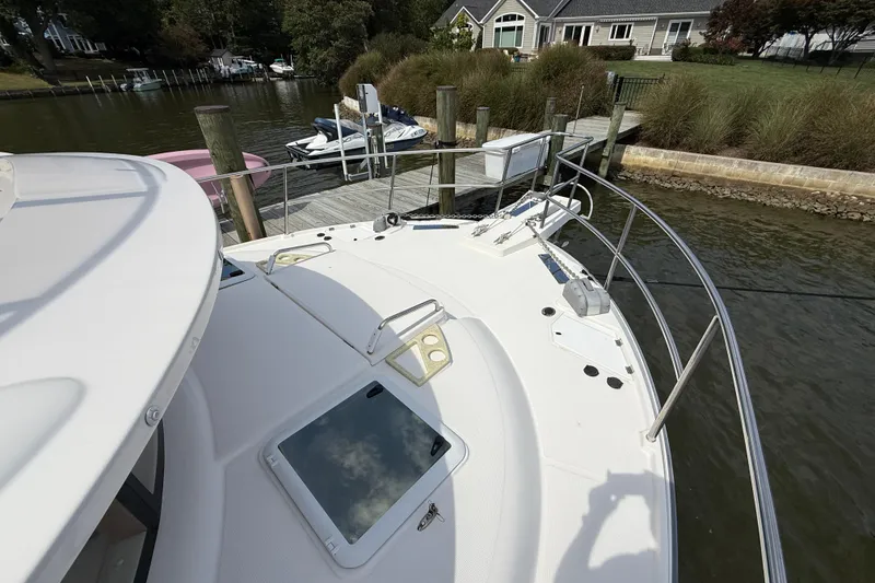 Slide: The Image of 2021 Ranger Tugs R-41CB yacht docked at a serene waterfront location. - 7