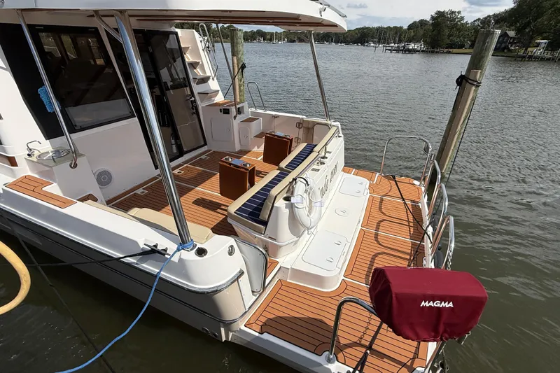 Slide: The Image of 2021 Ranger Tugs R-41CB boat with spacious deck and elegant wood finish. - 9