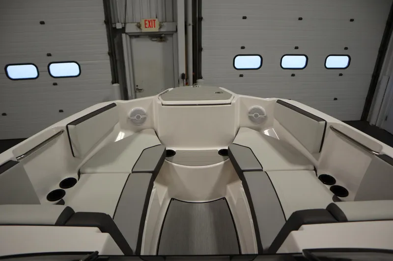Slide: The Image of 2026 Yamaha Boats AR220 interior with sleek seating and modern design in a garage setting. - 10