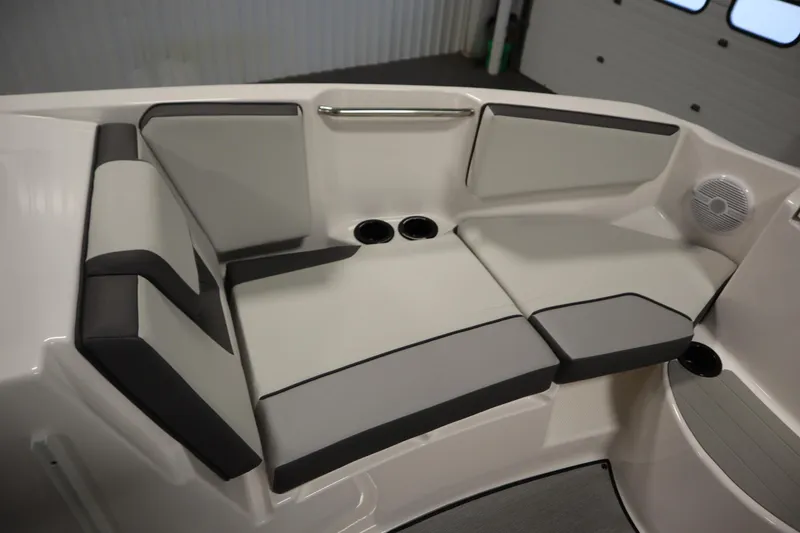 Slide: The Image of 2026 Yamaha Boats AR220 interior seating with cup holders and speaker. - 13