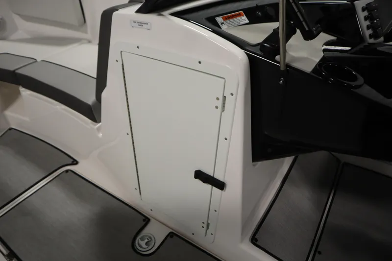 Slide: The Image of 2026 Yamaha Boats AR220 interior, featuring sleek seating and storage compartment. - 19