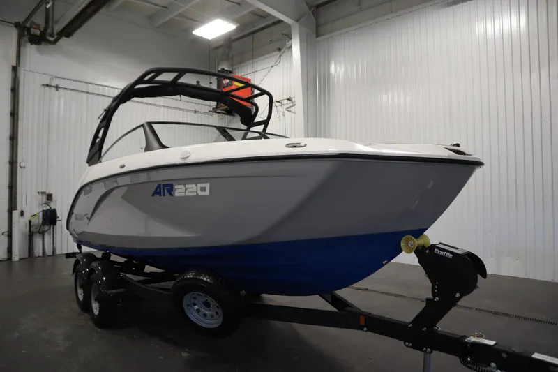 Slide: The Image of 2026 Yamaha Boats AR220 on trailer in indoor storage facility. - 2