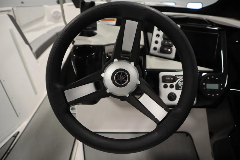 Slide: The Image of Steering wheel of 2026 Yamaha Boats AR220, featuring modern dashboard controls. - 22