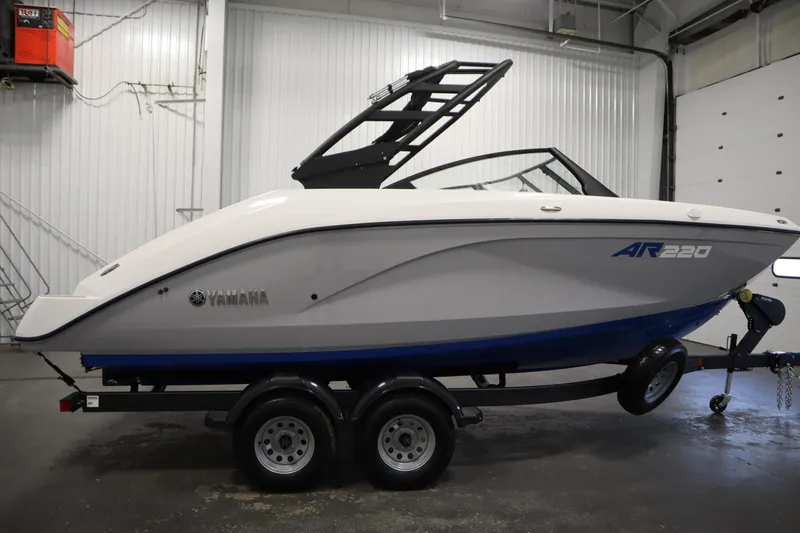 Slide: The Image of 2026 Yamaha Boats AR220 on trailer in indoor showroom. - 3