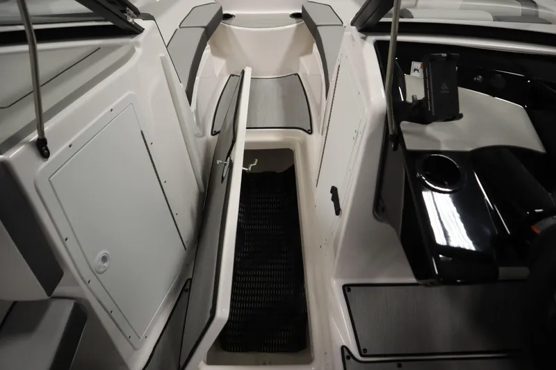 Slide: The Image of 2026 Yamaha Boats AR220 interior with open storage compartment and sleek design. - 30