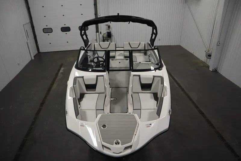 Slide: The Image of 2026 Yamaha Boats AR220 in a showroom, showcasing sleek design and spacious seating. - 8