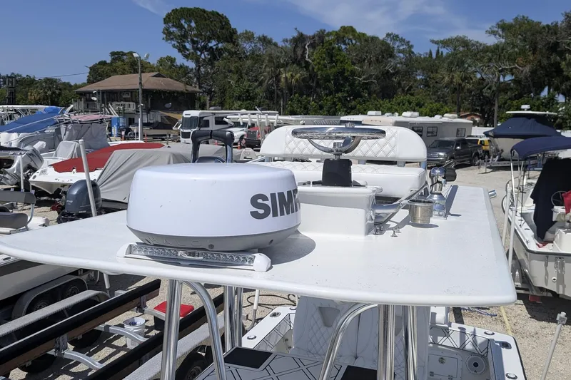 Slide: The Image of 1985 Contender 25 Sport boat with radar equipment, parked among other boats. - 14