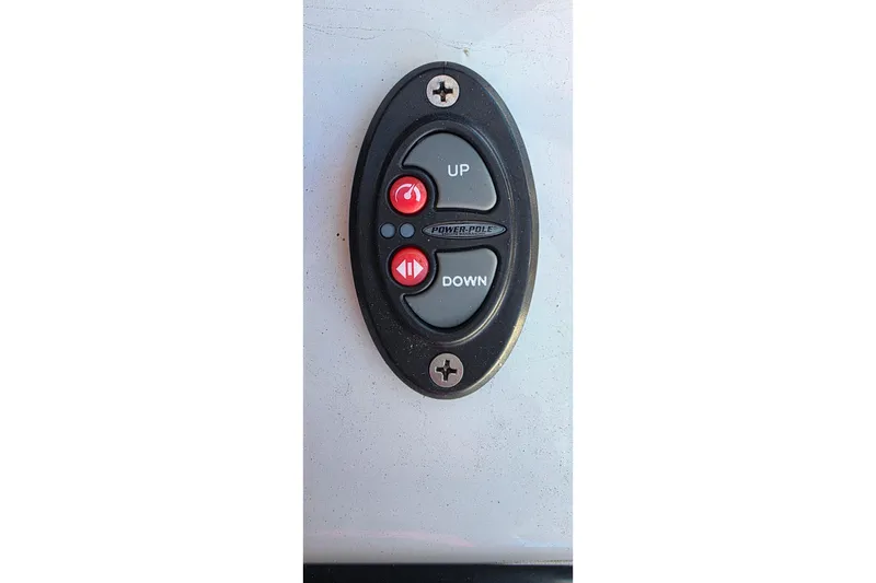 Slide: The Image of Control panel on a 1985 Contender 25 Sport boat, featuring up and down buttons. - 17