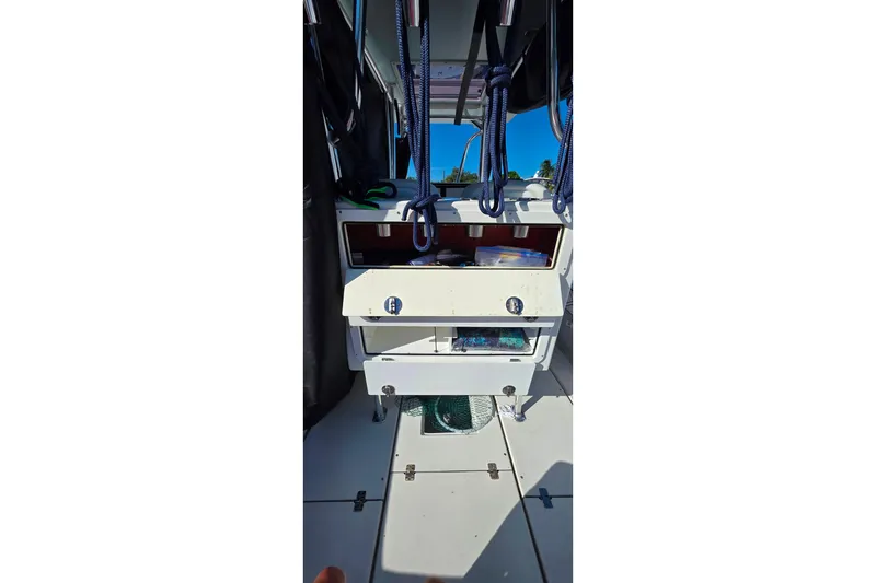 Slide: The Image of Interior view of a 1985 Contender 25 Sport boat with storage compartments. - 24