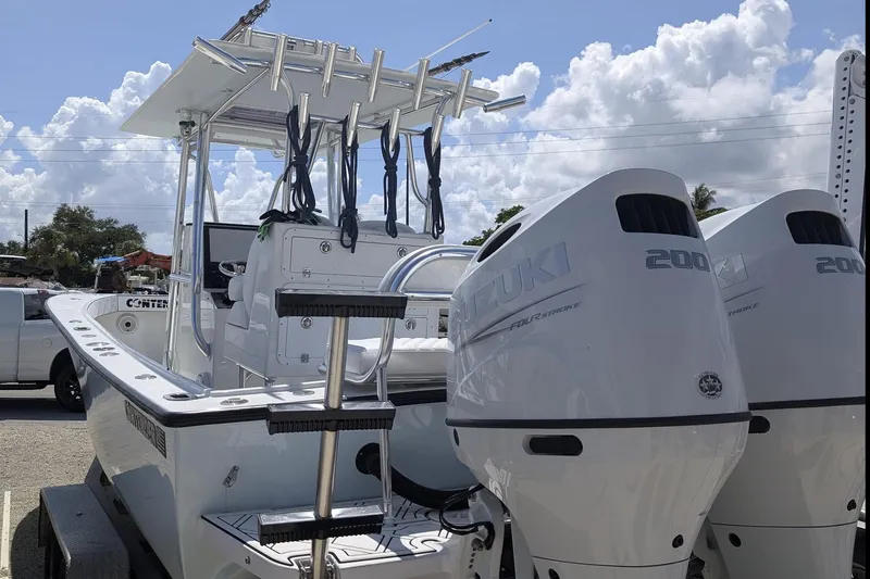 Slide: The Image of 1985 Contender 25 Sport boat with dual Suzuki 200 outboard engines on a trailer. - 5
