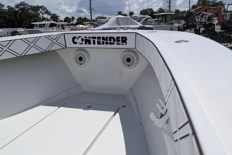 Slide: The Image of 1985 Contender 25 Sport boat console with modern controls and seating under a clear sky. - 9