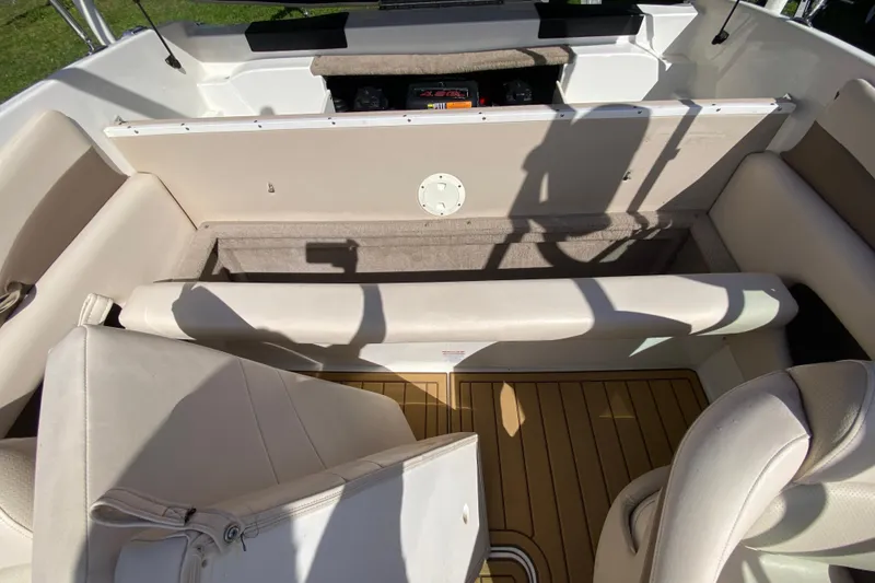 Slide: The Image of 2006 Chaparral 190 SSi boat interior with beige seating and wood-style flooring. - 16