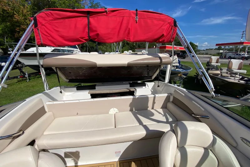 Slide: The Image of 2006 Chaparral 190 SSi boat interior with red canopy and beige seating. - 17