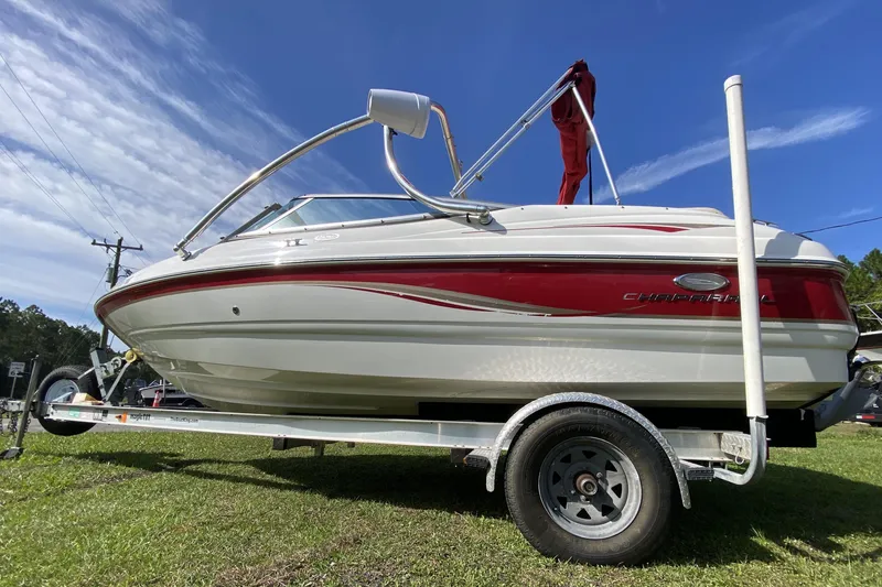 Slide: The Image of 2006 Chaparral 190 SSi boat on trailer, red and white design, parked on grass. - 5