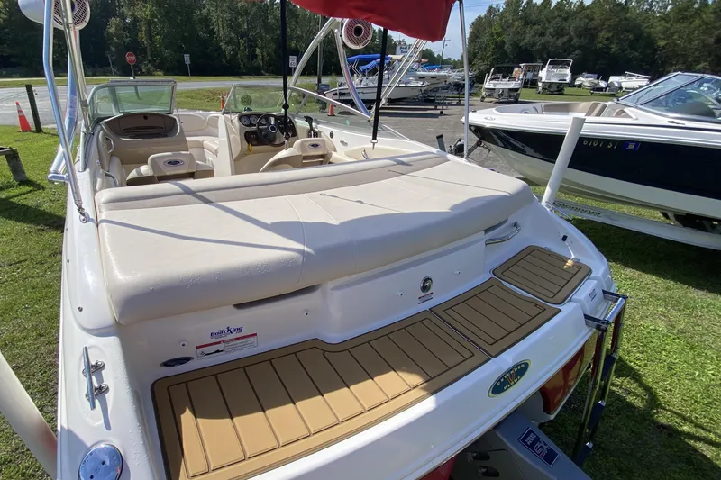 Slide: The Image of 2006 Chaparral 190 SSi boat with spacious seating and sleek design, parked outdoors. - 6