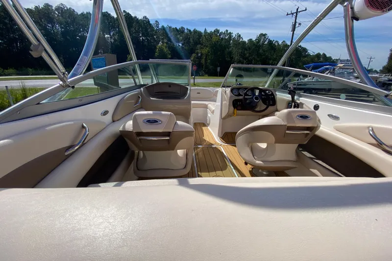 Slide: The Image of 2006 Chaparral 190 SSi boat interior with beige seating and steering wheel. - 7