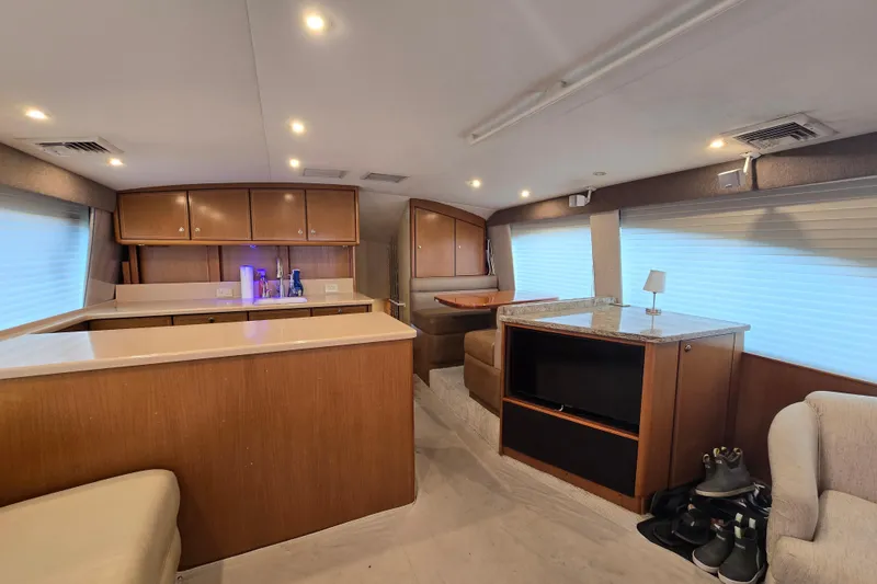 Slide: The Image of Luxurious interior of 2004 Ocean Yachts 50 Super Sport with modern kitchen and cozy seating area. - 11