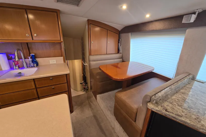 Slide: The Image of Luxurious interior of 2004 Ocean Yachts 50 Super Sport with dining area and kitchenette. - 12