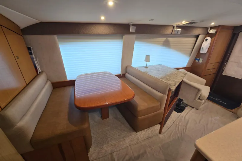 Slide: The Image of 2004 Ocean Yachts 50 Super Sport interior with dining area and seating. - 14