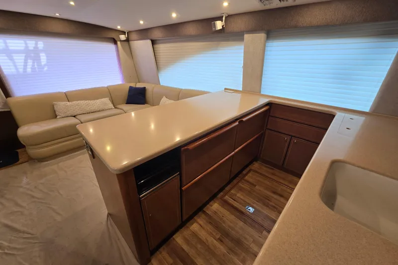 Slide: The Image of Luxurious interior of 2004 Ocean Yachts 50 Super Sport with modern kitchen and seating area. - 15