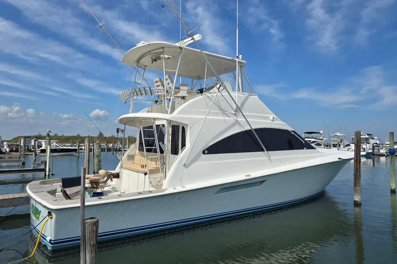Slide: The Image of 2004 Ocean Yachts 50 Super Sport docked at marina under blue sky. - 2