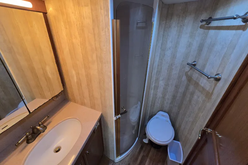 Slide: The Image of Bathroom interior of 2004 Ocean Yachts 50 Super Sport with shower, sink, and toilet. - 23