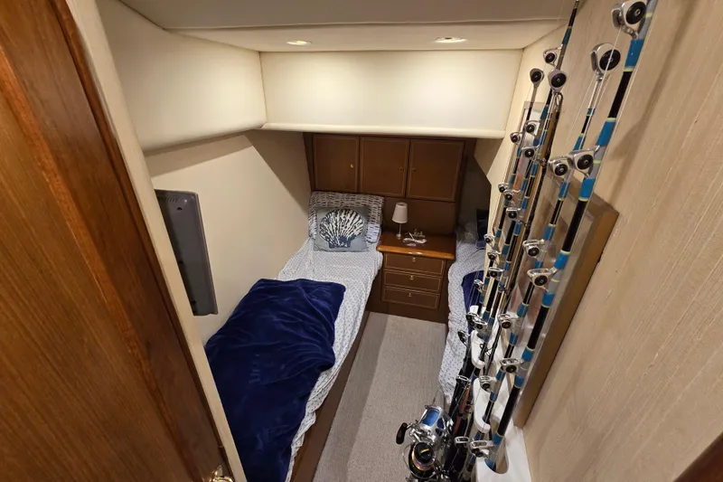 Slide: The Image of 2004 Ocean Yachts 50 Super Sport cabin with twin beds and fishing rods. - 24