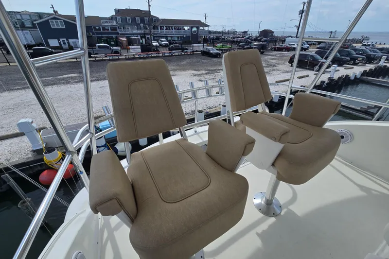 Slide: The Image of 2004 Ocean Yachts 50 Super Sport helm chairs overlooking marina and waterfront. - 32