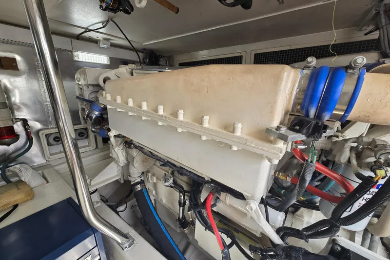 Slide: The Image of Engine room of 2004 Ocean Yachts 50 Super Sport, showcasing mechanical components and wiring. - 50