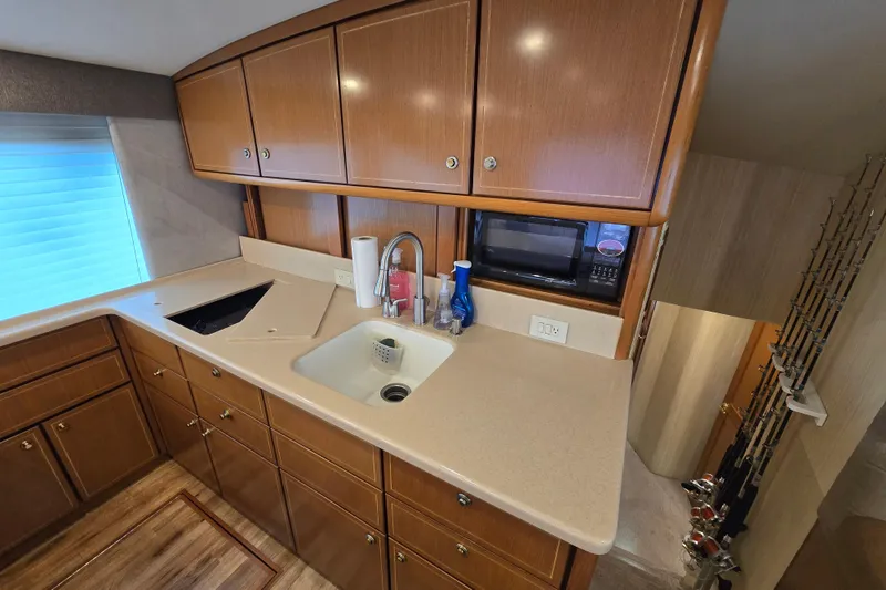 Slide: The Image of 2004 Ocean Yachts 50 Super Sport kitchen with wooden cabinets and modern appliances. - 13