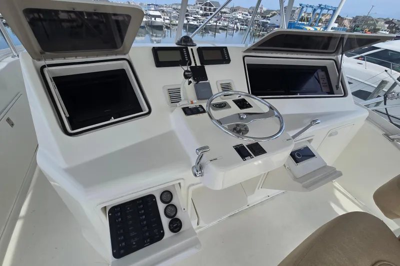 Slide: The Image of Cockpit of 2004 Ocean Yachts 50 Super Sport with steering wheel and navigation controls. - 28