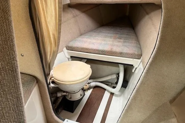 Slide: The Image of Interior of 1991 Corsair F-27 #227 sailboat with compact toilet and cushioned berth. - 11