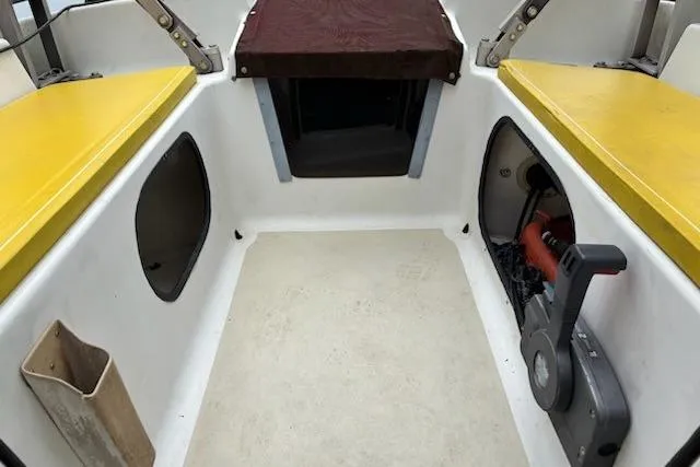 Slide: The Image of Interior of 1991 Corsair F-27 #227 sailboat with yellow seating and storage compartments. - 14