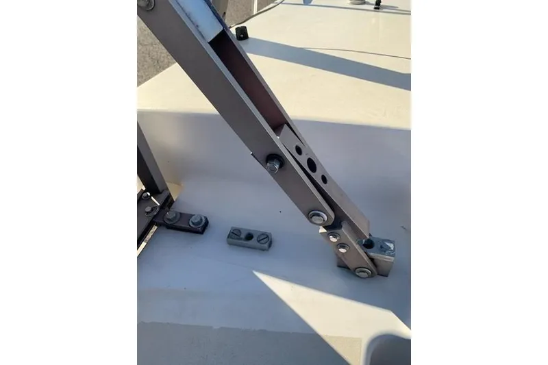 Slide: The Image of Close-up of Corsair F-27 #227 sailboat hardware, showcasing metal brackets and bolts, 1991 model. - 16