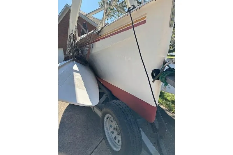 Slide: The Image of 1991 Corsair F-27 #227 sailboat on trailer, side view with red stripe. - 5
