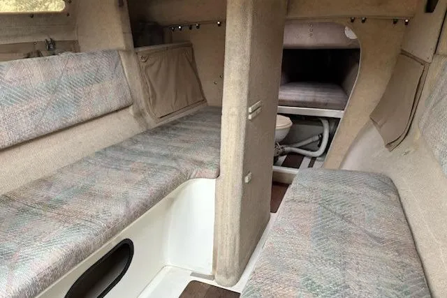 Slide: The Image of Interior of a 1991 Corsair F-27 #227 sailboat, featuring cozy seating and compact design. - 7